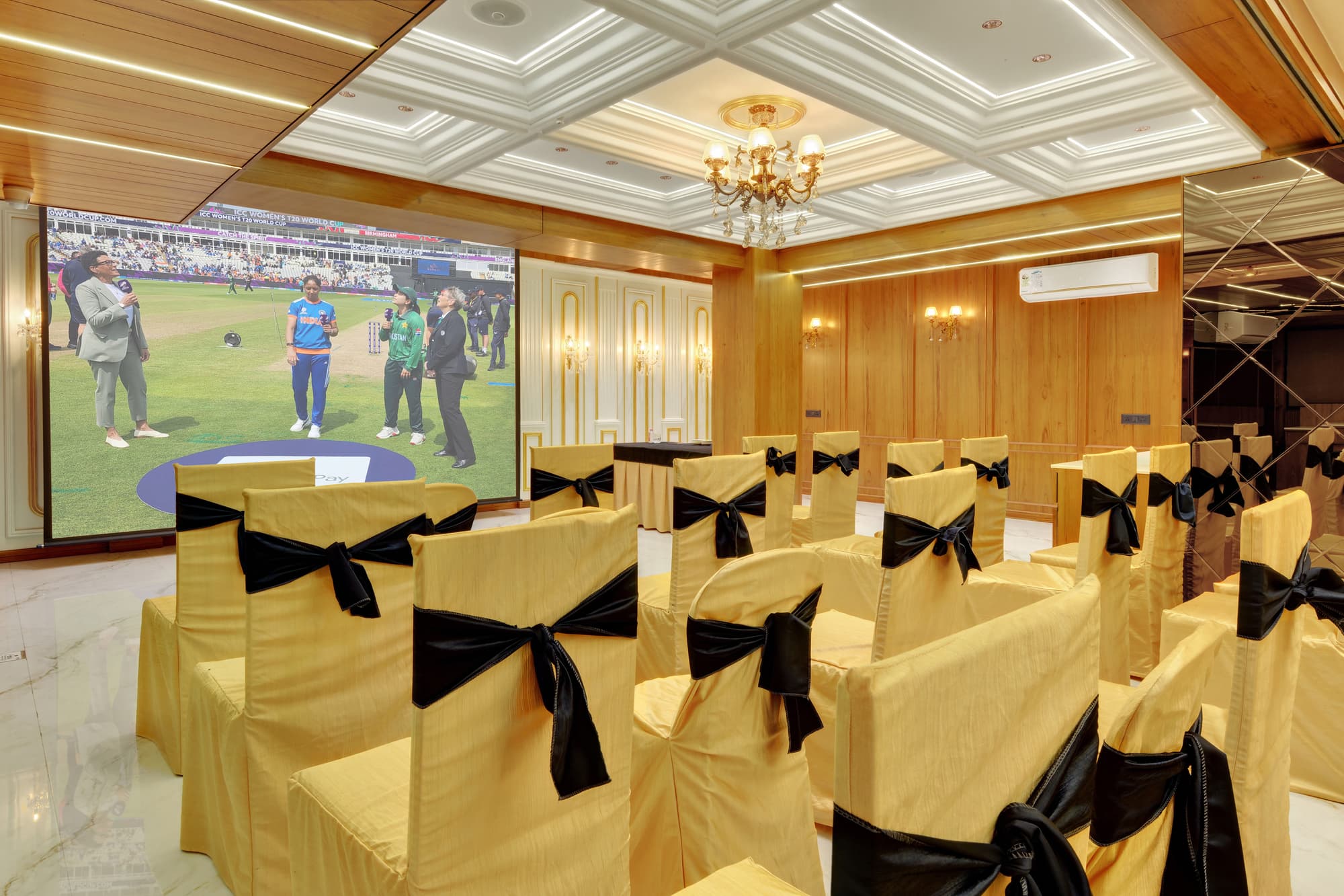 Hotel Shital Inn Conference Room screen and rows of guest seating